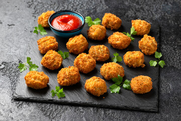 Potato croquettes with ham and cheese on stone board