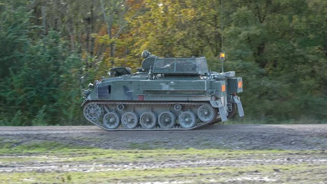 British army Bulldog FV432 driving along a dirt track. Wilts UK