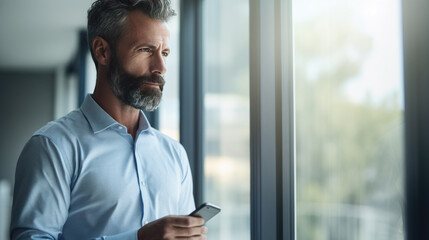 Fototapeta premium Businessman using his phone at work in the office.