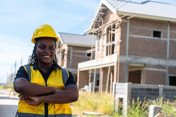 success and construction work Concept.Black female engineer, contractor standing with arms crossed...