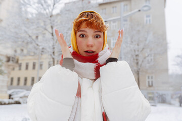 Positive portrait teenage girl in snowfall cityscape