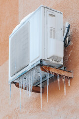 air conditioner in icicles of ice - 687610578