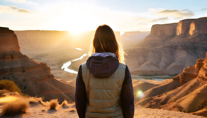 Young adult female standing in front of a scenic canyon landscape