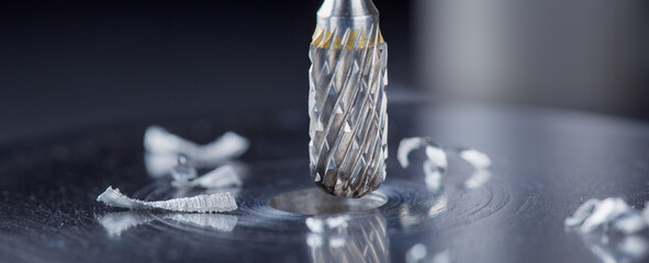 Milling cutter make sink in hole in steel billet. Locksmith work.
