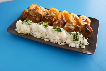 baked pork ribs with rice and peaches as tasty,dinner dish close up