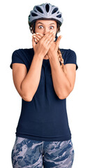 Beautiful caucasian woman wearing bike helmet shocked covering mouth with hands for mistake. secret concept.