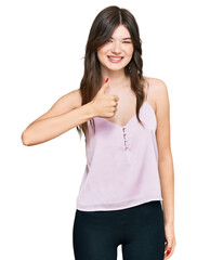 Fototapeta premium Young beautiful caucasian girl wearing casual clothes doing happy thumbs up gesture with hand. approving expression looking at the camera showing success.
