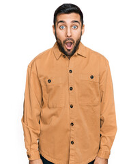 Young hispanic man wearing casual clothes afraid and shocked with surprise expression, fear and excited face.