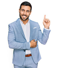 Young hispanic man wearing business jacket smiling happy pointing with hand and finger to the side