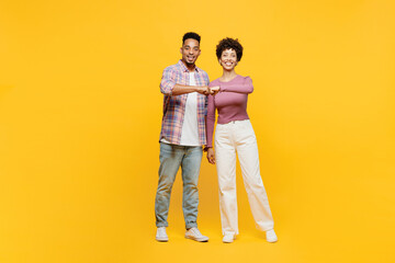 Full body young happy couple two friends family man woman of African American ethnicity wearing...