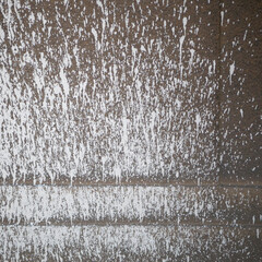 old wall of a house sprayed with white paint