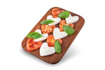 Caprese salad with tomatoes and mozzarella in the shape of hearts for Valentine's Day on a white isolated background
