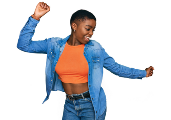 Young african american woman wearing casual clothes dancing happy and cheerful, smiling moving casual and confident listening to music