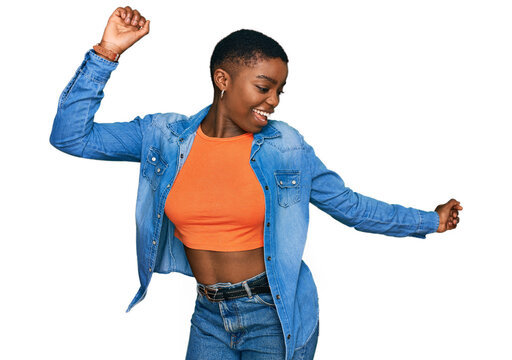 Young african american woman wearing casual clothes dancing happy and cheerful, smiling moving casual and confident listening to music