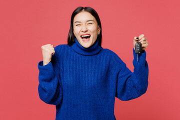 Young fun woman of Asian ethnicity she wear blue sweater casual clothes hold key fob keyless system...