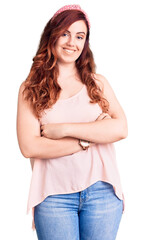 Obraz premium Young beautiful woman wearing casual clothes and diadem happy face smiling with crossed arms looking at the camera. positive person.