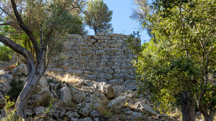 Stone wall in ancient city Amos near town or village of Turunc, Turkey. It was located in Rhodian Peraia in Caria on Mediterranean coast