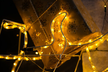 Closeup of Christmas Gift in Golden Paper on Sled