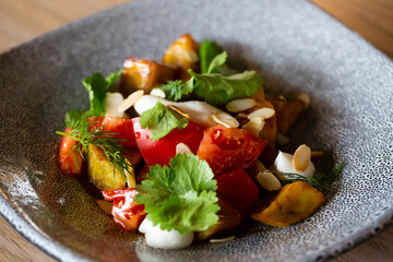Vegetarian Eggplant Salad with Baked Aubergine, Cherry Tomatoes and Cilantro Close Up. Macro Photo of Grilled Eggplants and Cottage Cheese with Fresh Dill, Parsley, Sesame Seeds and Spicy Oil