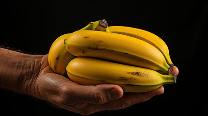 Hand holding bunches of bananas. Concept of natural abundance, tropical freshness, and the wholesome joy of nutritious, ripe fruit.