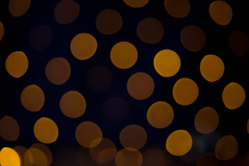 Festive Bokeh with Large Gold Ovals on Dark Background