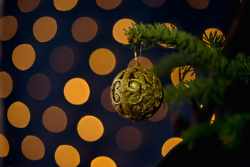 Glittering Golden Christmas Ornament on Fir Branch
