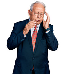 Senior man with grey hair wearing business suit and glasses tired hands covering face, depression and sadness, upset and irritated for problem