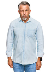 Middle age grey-haired man wearing casual clothes puffing cheeks with funny face. mouth inflated with air, crazy expression. - obrazy, fototapety, plakaty