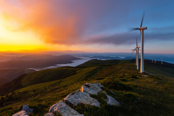 Wind turbines farm at sunrise, Oiz mountain, Basque Country, Spain - 687634515