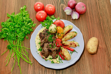 beef tikka kabab bbq boti with potato veggies, tomato, onion and coriander served in dish isolated on table top view of arabic food