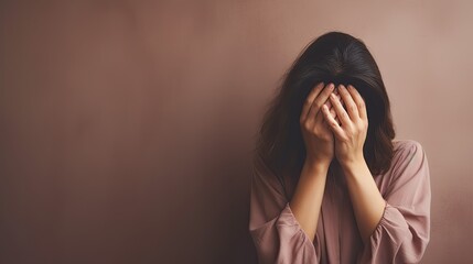 exhausted mother covering her face with hands