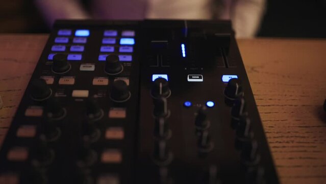 midi controller close up. Disc jockey playing music with midi controller. Professional dj plays set on stage in night club. a Beat Sampler with Color Drum Pads and Samples in Studio Environment. 