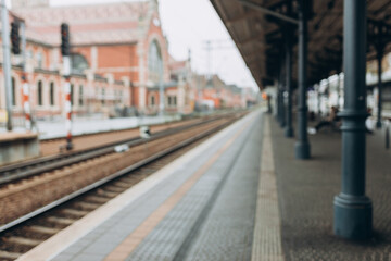 Blurred background of empty train station. Blurred scenery of the platform, vacation concept