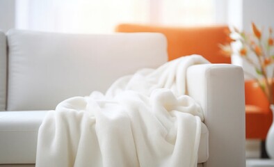    Warm background, white plush blanket draped over the sofa.
