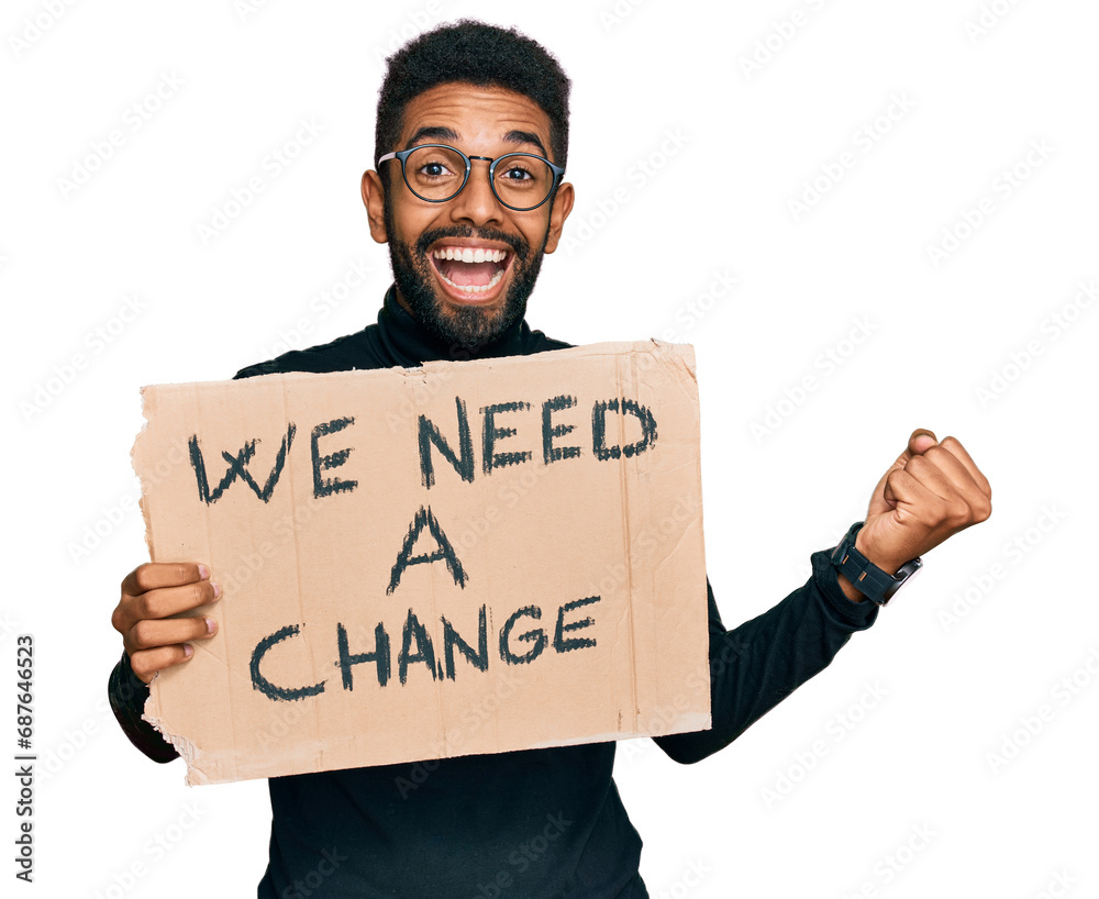 Wall mural Young african american man holding we need a change banner screaming proud, celebrating victory and success very excited with raised arms