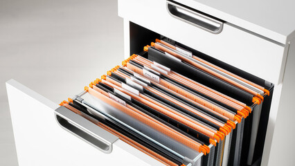 Closeup of drop files in white drawer.
