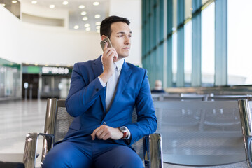 Businessman on call at airport terminal