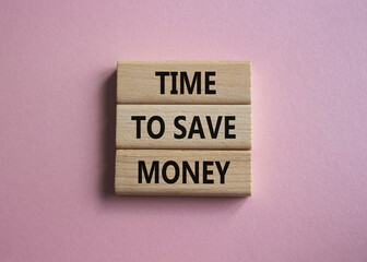 Time to save money symbol. Wooden blocks with words Time to save money. Beautiful pink background. Business and Time to save money concept. Copy space.