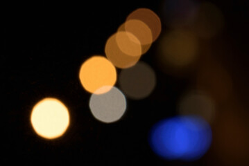 Lights on the street in the night. Blurred. Copy space. Background