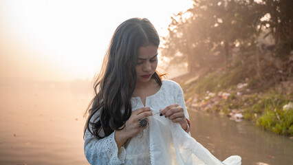 Portrait of a beautiful Indian girl, wearing traditional dress, outdoor nature background