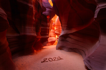 Happy New Year 2024: New Year 2024 concept with light in the distance in the breathtaking Antelope Cave in Arizona USA - obrazy, fototapety, plakaty