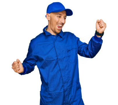 Bald man with beard wearing builder jumpsuit uniform dancing happy and cheerful, smiling moving casual and confident listening to music