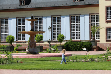 Baby girl chasing storks in Orangerie Park - Strasbourg - 687660771