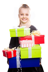 Blonde girl holding in hands lots of boxes with gifts on isolated background