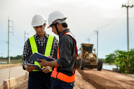 Highway engineers discuss plans for construction improvement based on roadworks. Soil Fill, Backfill Compaction for Sub base, Base Course, Surveyor Engineer inspector in highway construction.