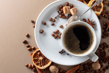 Black coffee  with spices on a beige background.