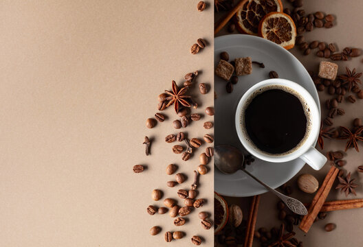 Black coffee  with spices on a beige background.