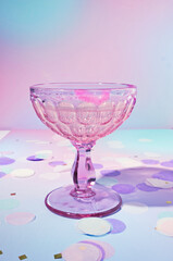 A Lipstick Stained Vintage Champagne Glass on a Dreamy, Pastel Purple Background