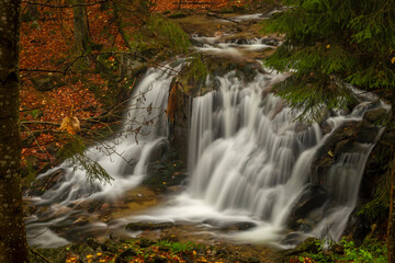 Fototapeta na wymiar Ponikly waterfall with flood water after night rain in autumn morning