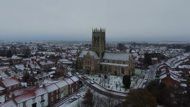 Drone shot. Christmas snow winter scene. Church of England. Parish church in English countryside. Christian church worship UK. 